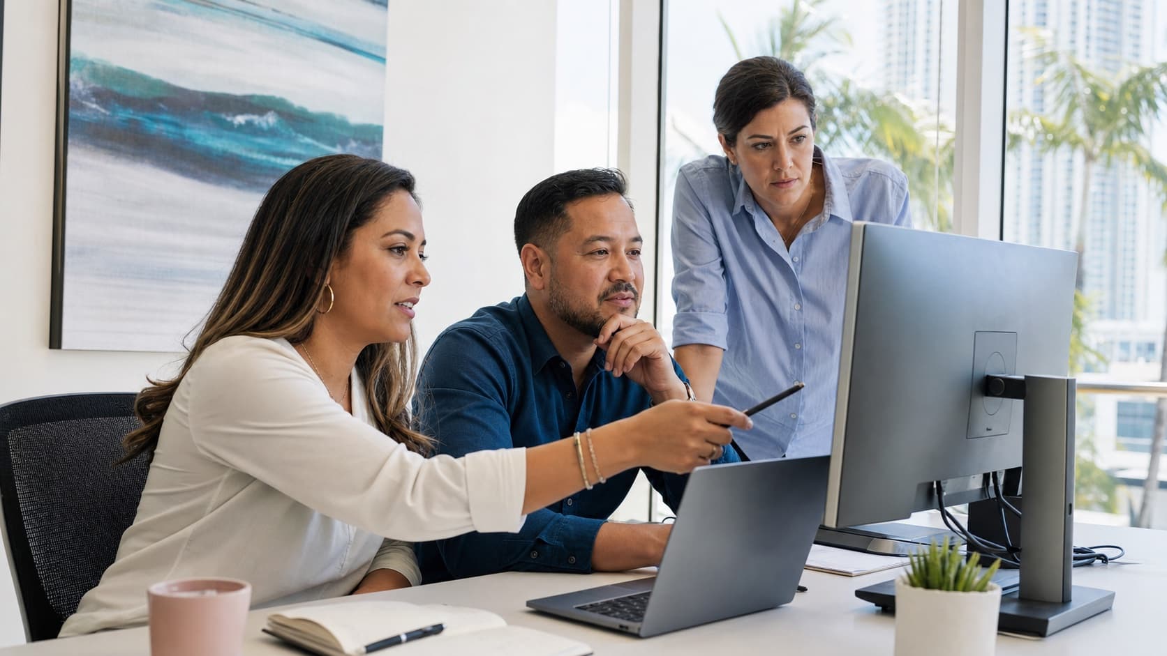 A business team reviewing a workflow on their computers